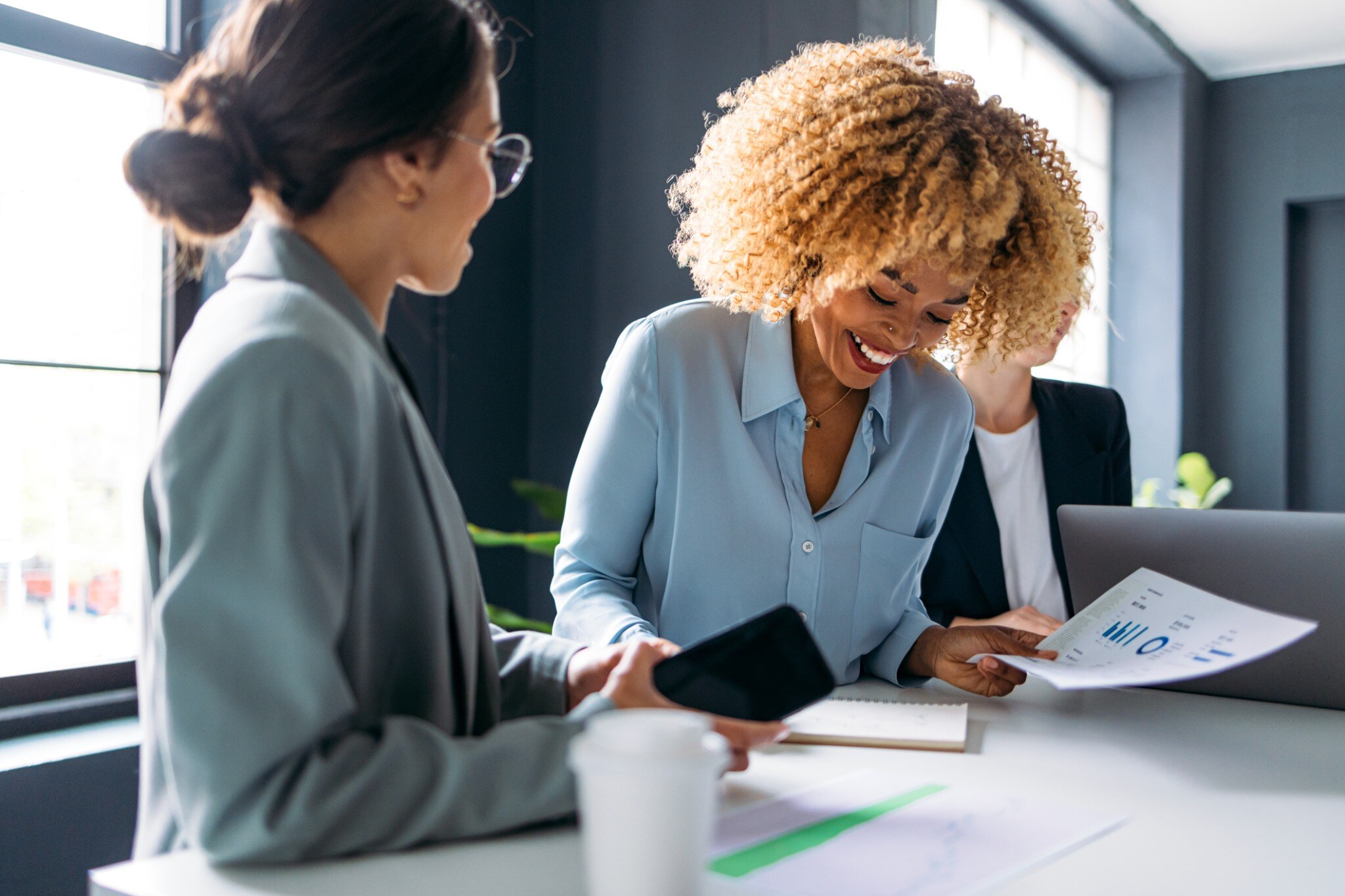 Tax professionals reviewing business documents and digital information